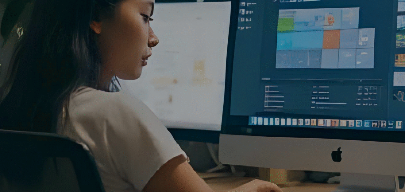 Woman sitting at her desk using computer AI at work